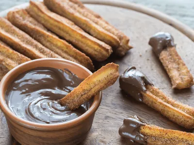 Qual o país de origem do churros?